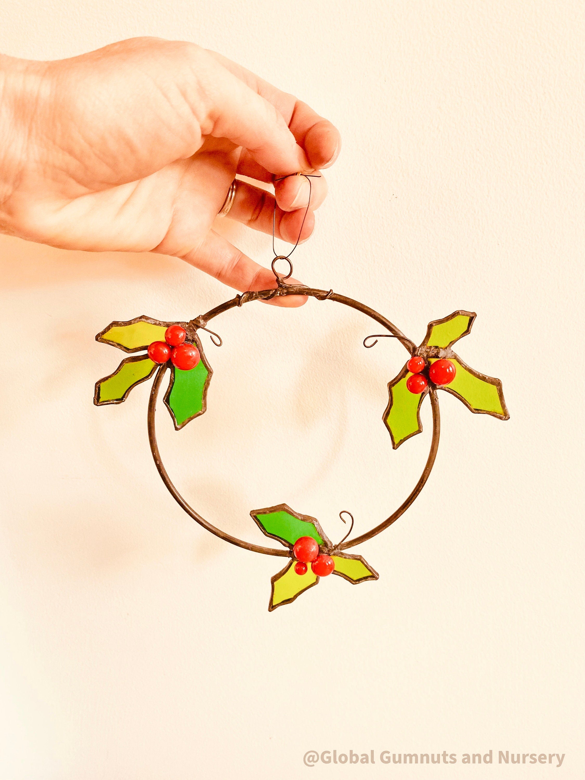 Stained Glass Wreath: Festive wreath with stained glass holly and berries.