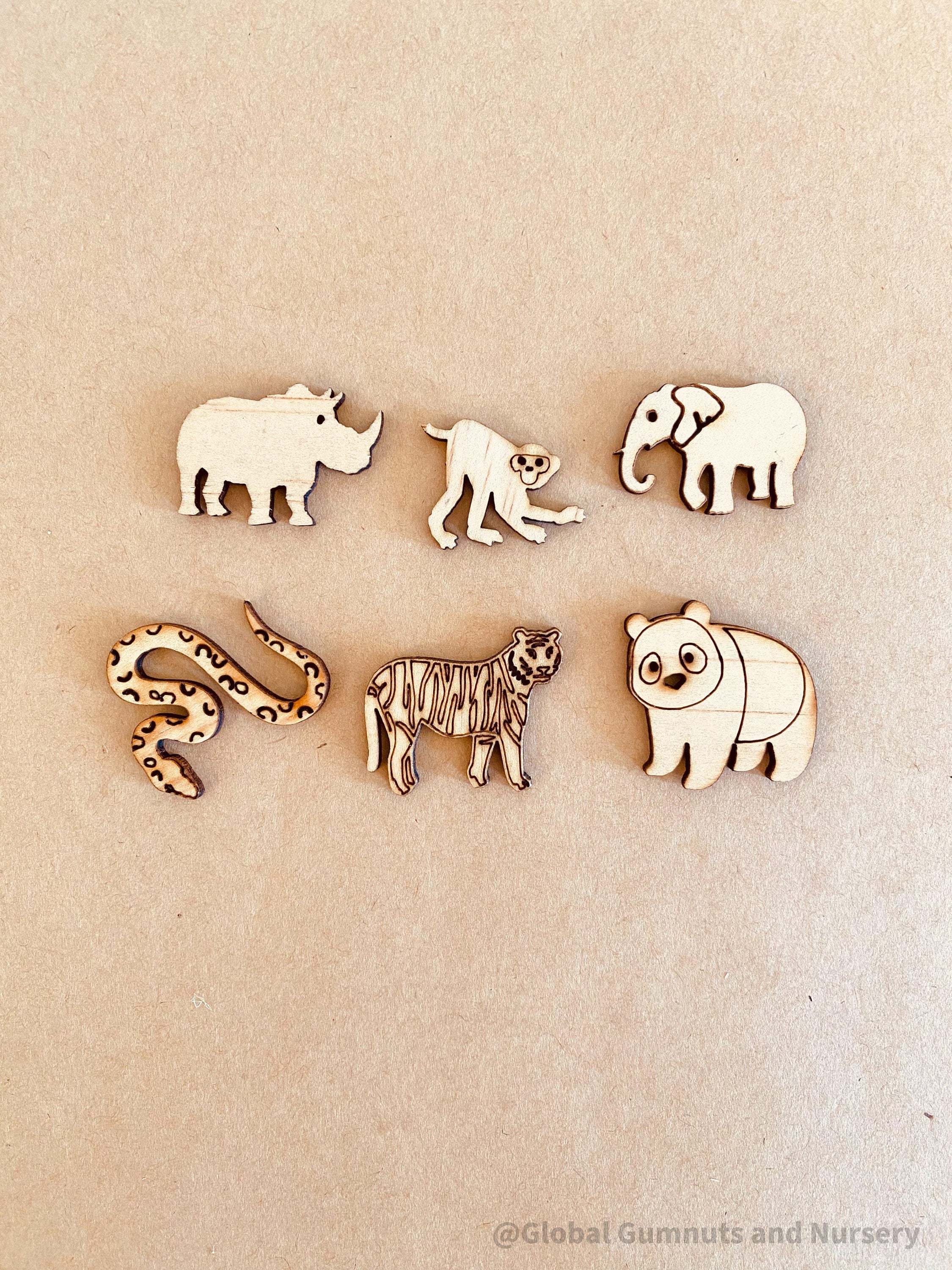 Wild Animal Embellishments: Set of six wooden exotic animal decorations.