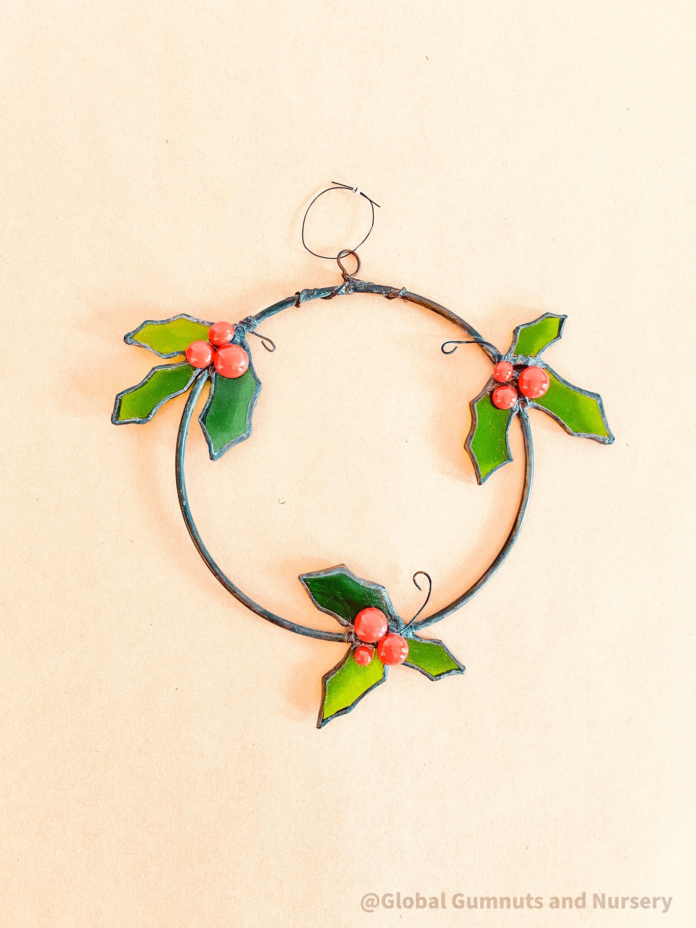 Stained Glass Wreath: Festive wreath with stained glass holly and berries.