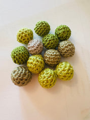 Crochet beaded wooden balls in warm or cool tones, perfect for sensory play, jewelry-making, or decor.