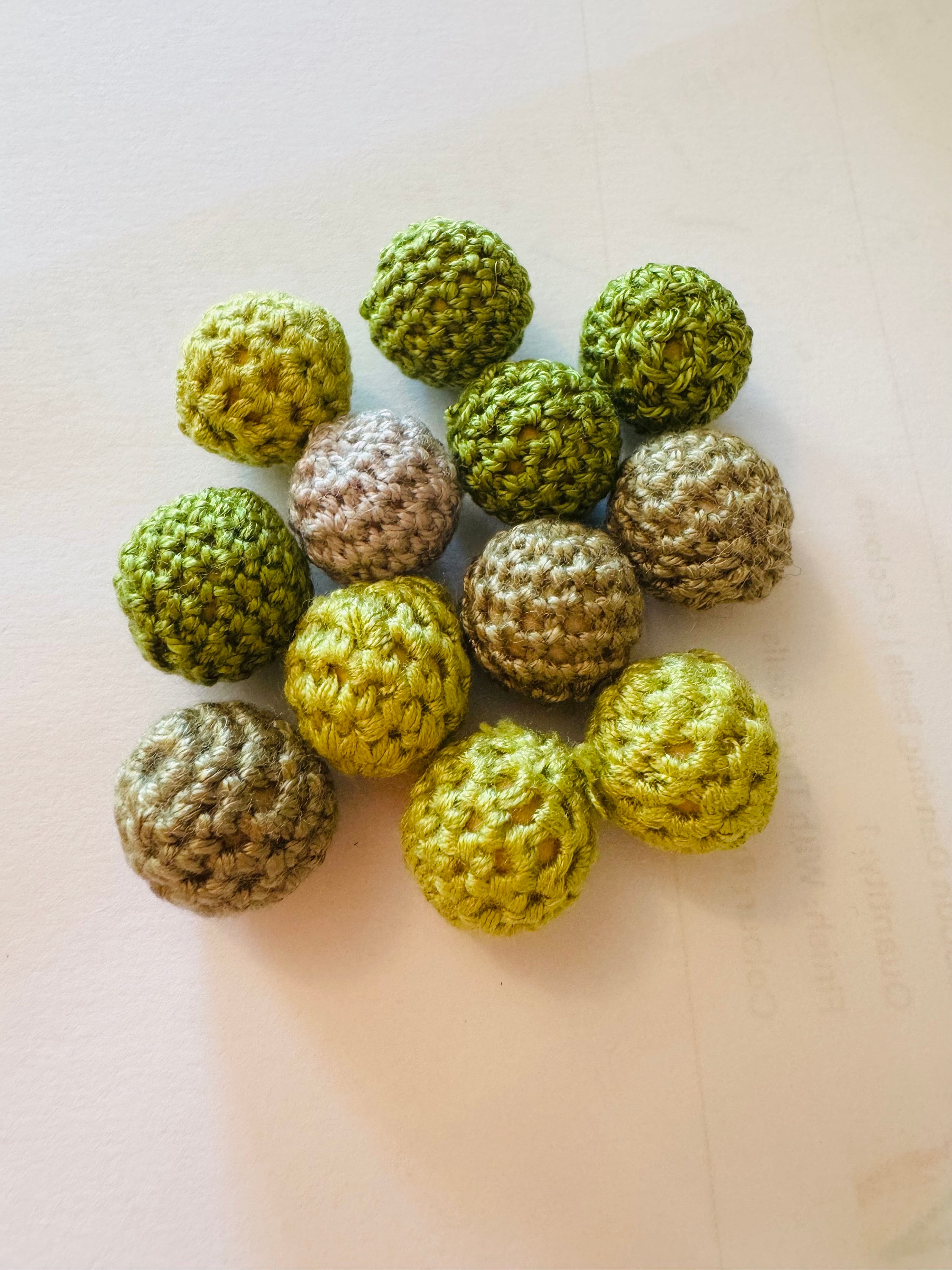 Crochet beaded wooden balls in warm or cool tones, perfect for sensory play, jewelry-making, or decor.