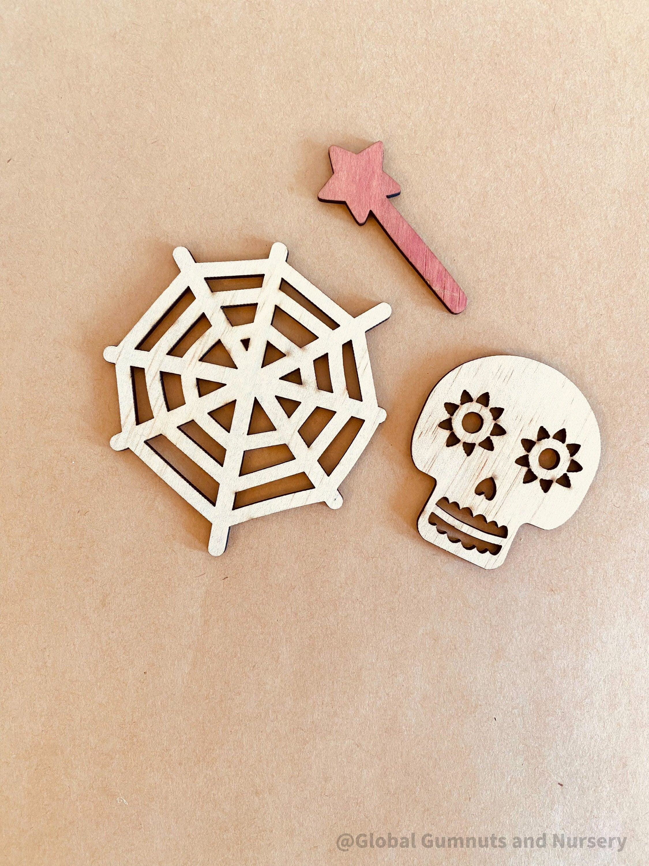 Halloween Embellishments Set: Halloween-themed wooden decorations including spiders and skulls.