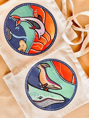 Linen library bag featuring Indigenous art of dolphins or whales, a practical and cultural keepsake.