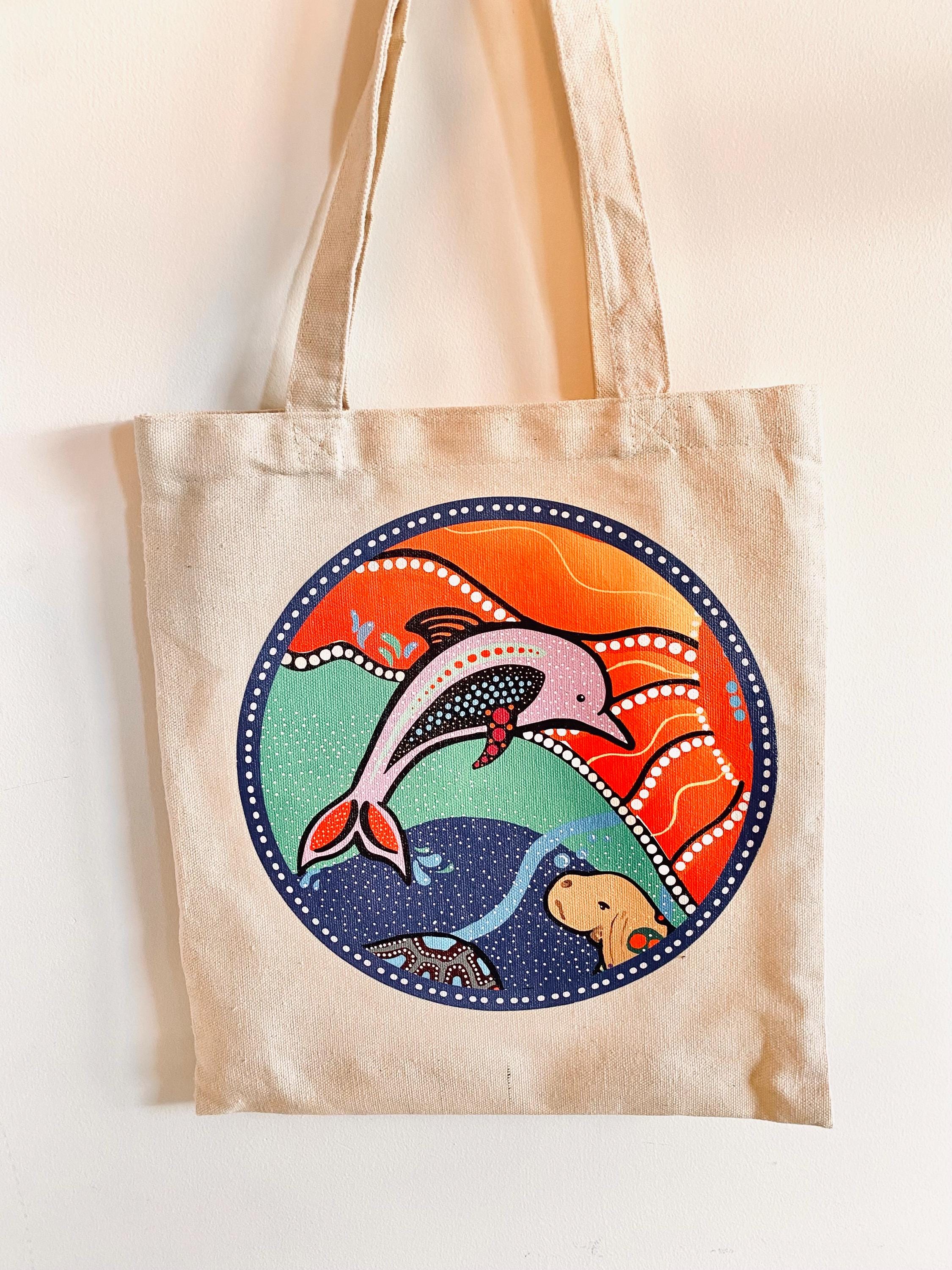 Linen library bag featuring Indigenous art of dolphins or whales, a practical and cultural keepsake.