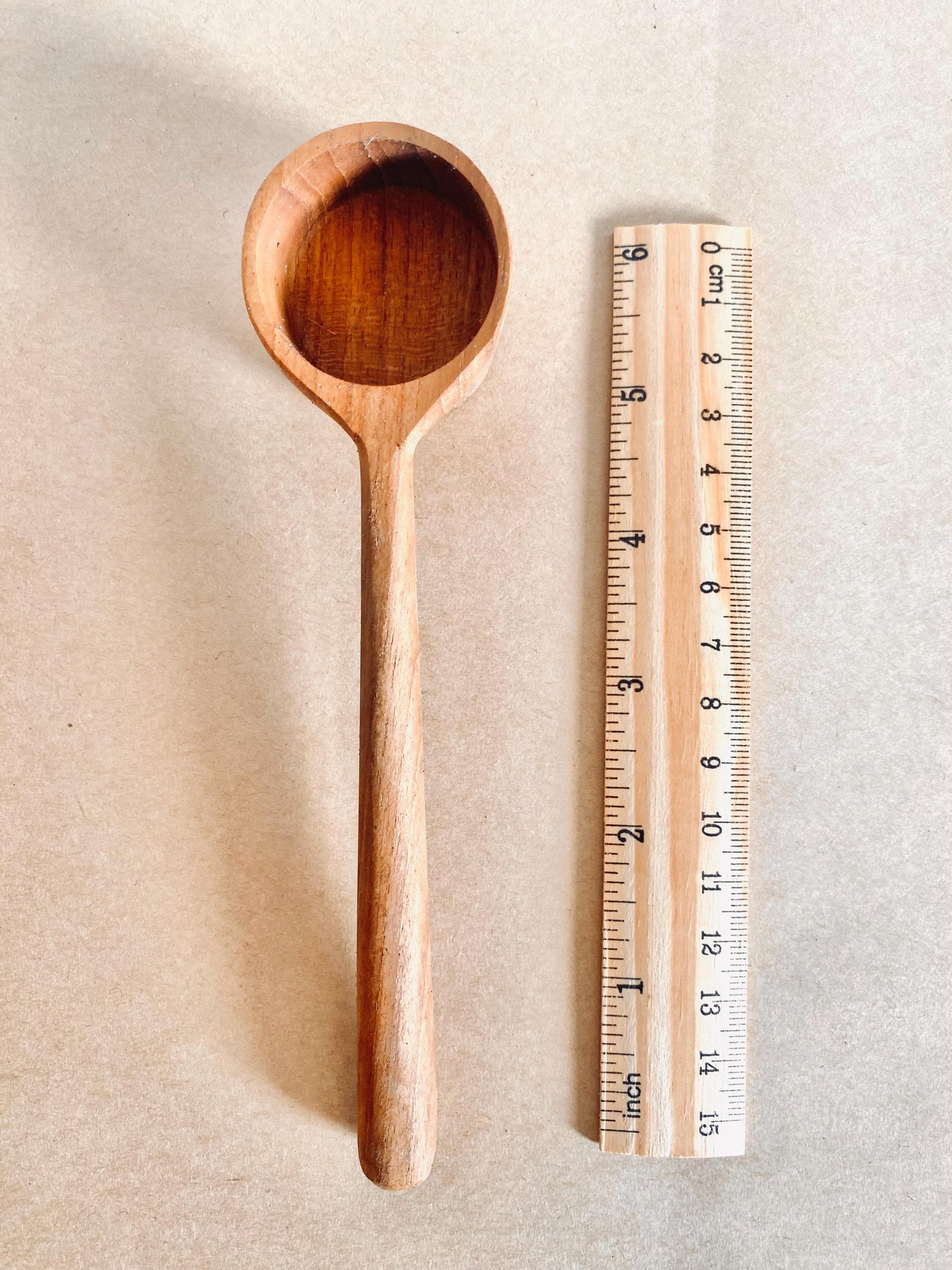 teak teaspoon scoops: natural wooden scoops for children’s activities.