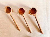teak teaspoon scoops: natural wooden scoops for children’s activities.