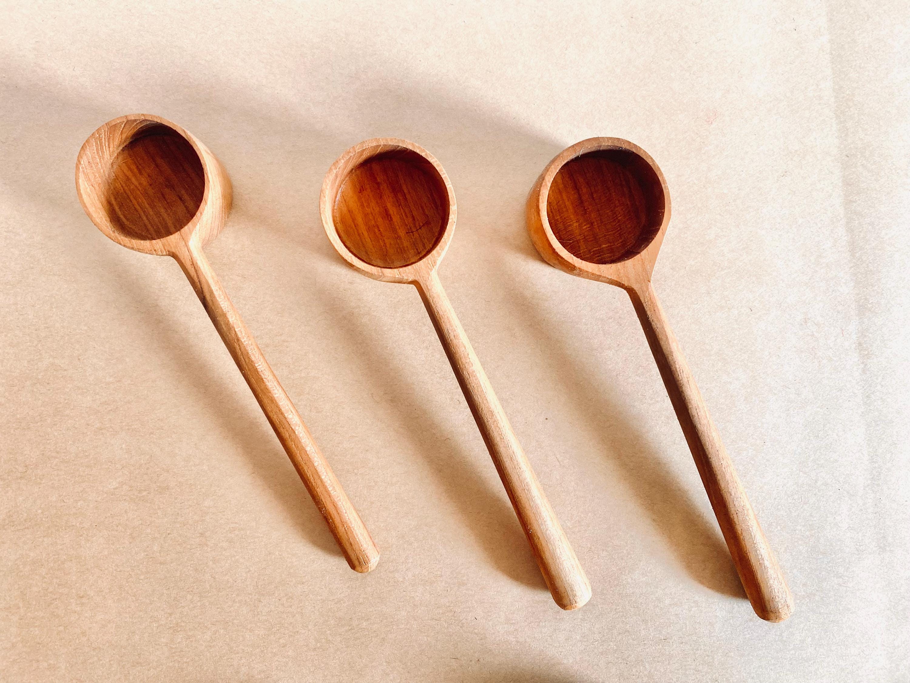 teak teaspoon scoops: natural wooden scoops for children’s activities.