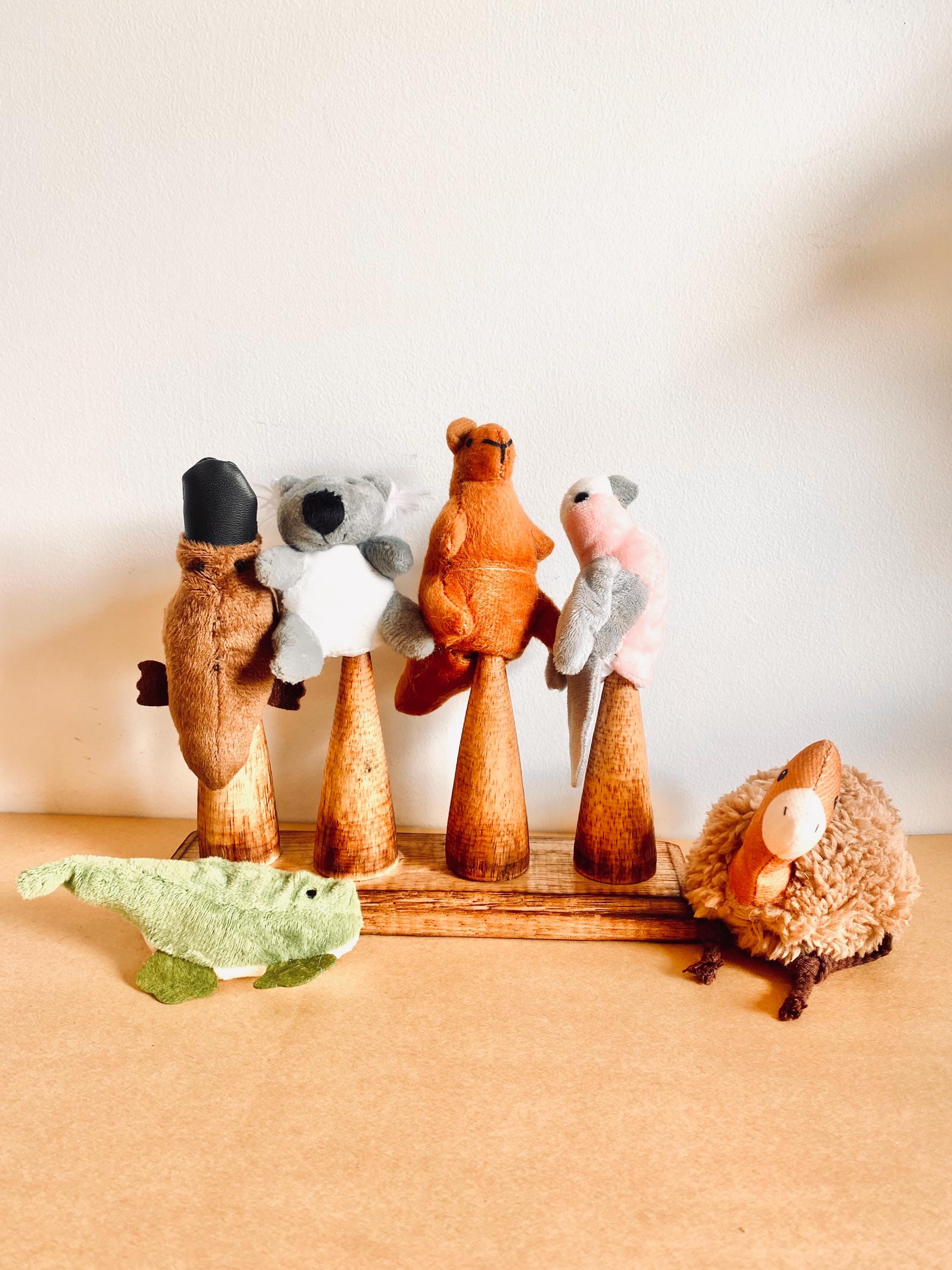 Wooden Finger Puppet Stand: Wooden stand with prongs for organizing finger puppets.