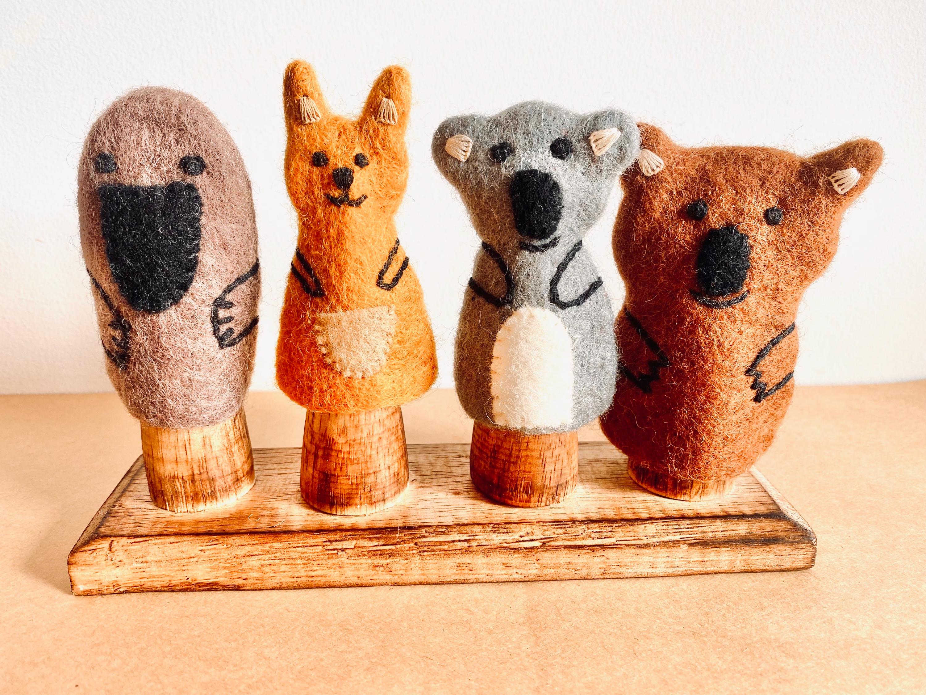 Wooden Finger Puppet Stand: Wooden stand with prongs for organizing finger puppets.