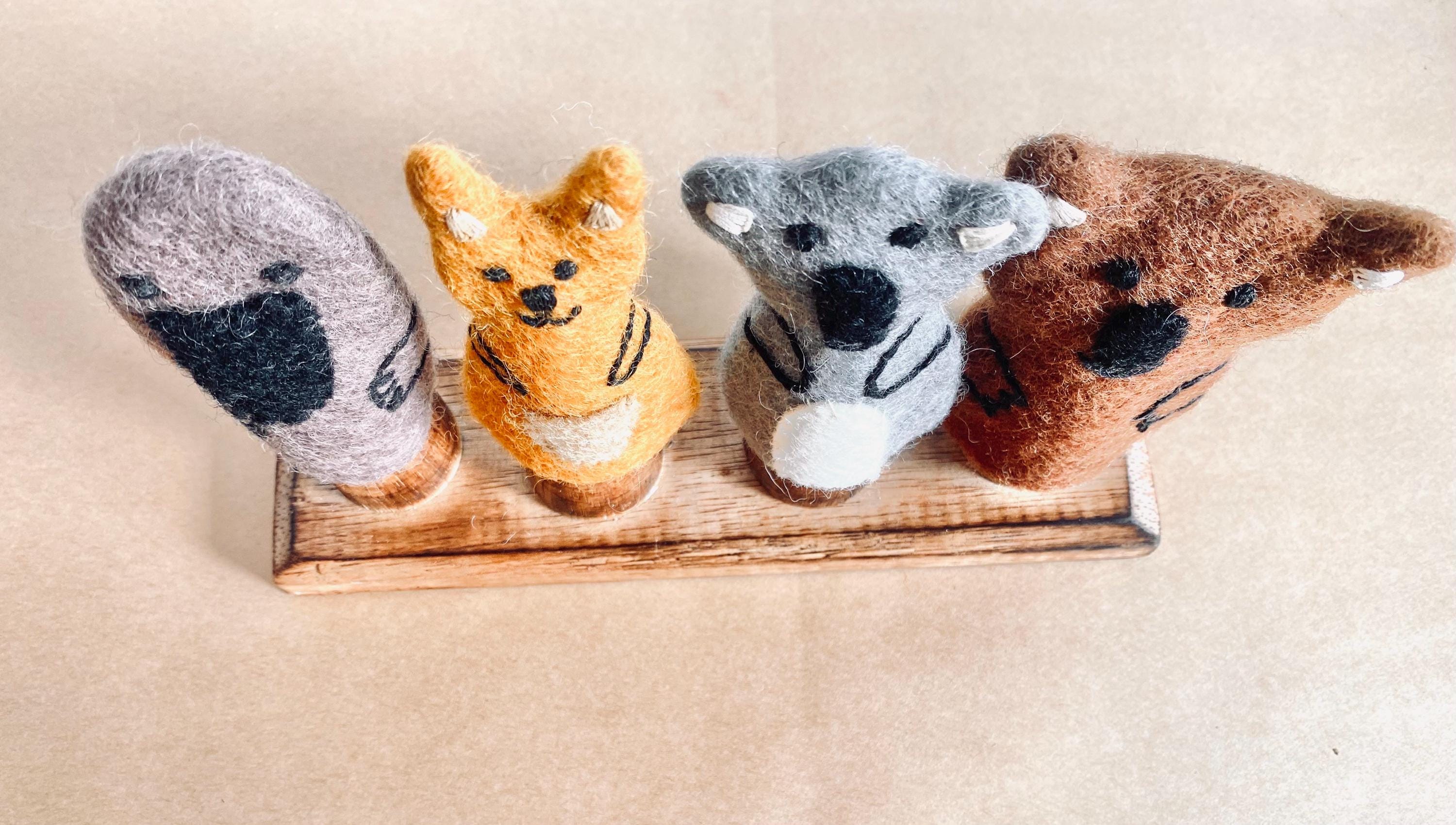Wooden Finger Puppet Stand: Wooden stand with prongs for organizing finger puppets.