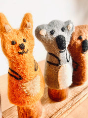 Wooden Finger Puppet Stand: Wooden stand with prongs for organizing finger puppets.