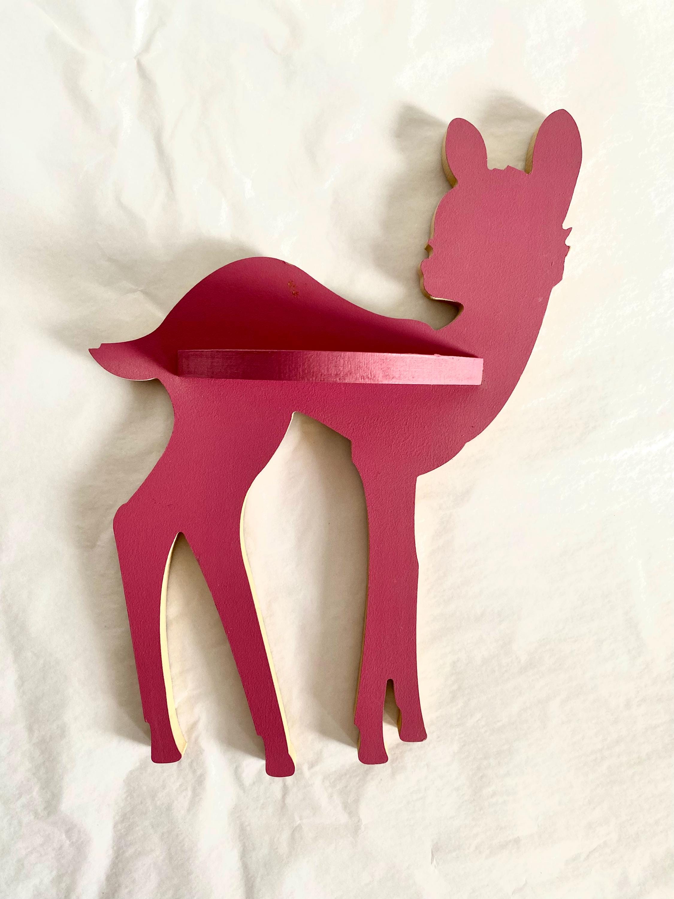 Burgundy wooden deer shelf with hooks, ideal for kids' rooms or adding rustic charm to any space. Customizable options available.