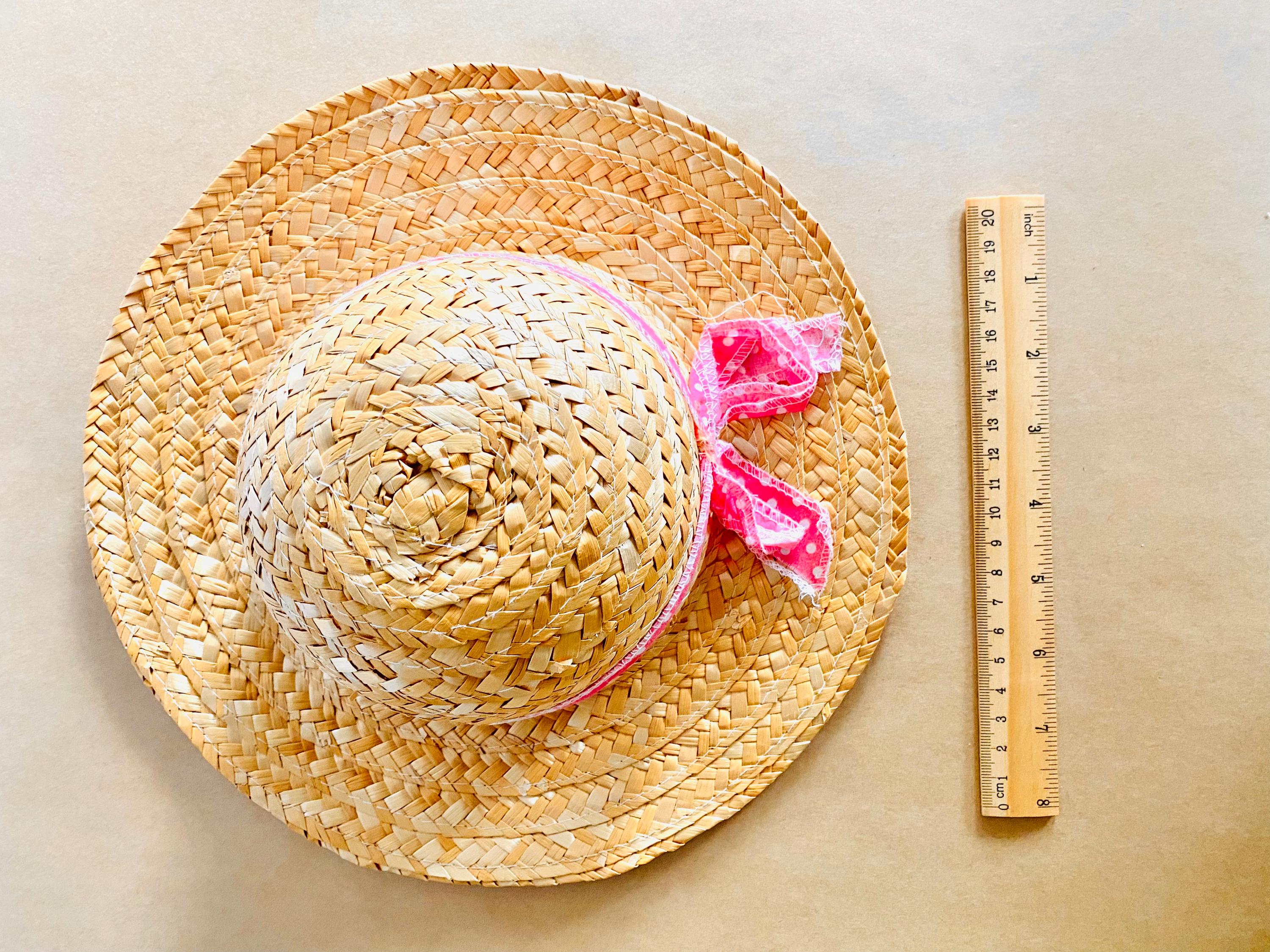 Plain straw hat with a pink ribbon, perfect for doll dress-up or adding rustic charm to decor projects.