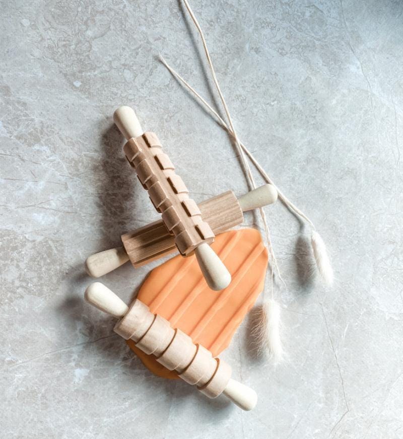 Set of 3 Patterned Rolling Pins: Wooden rolling pins with various patterns for creative play.