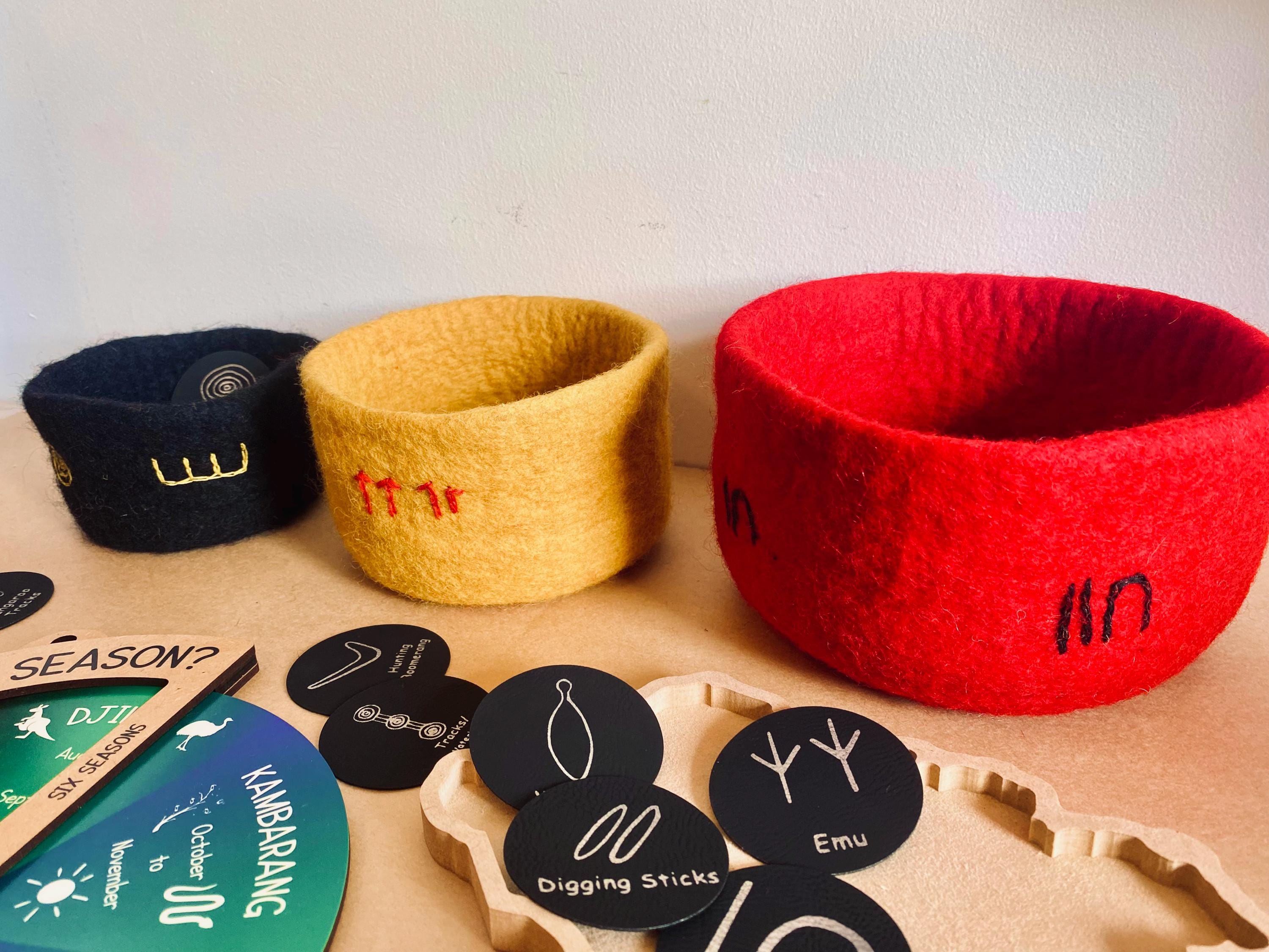 Indigenous nested bowl set in Australian flag colors, adorned with cultural symbols for NAIDOC Week.