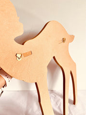 Burgundy wooden deer shelf with hooks, ideal for kids' rooms or adding rustic charm to any space. Customizable options available.