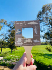 kids wooden view finder: nature exploration tool for observing clouds and leaves.