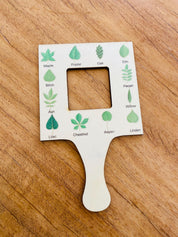 kids wooden view finder: nature exploration tool for observing clouds and leaves.