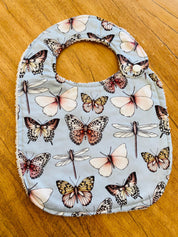 Butterfly Collection Bib: Handmade bib featuring butterfly illustrations.