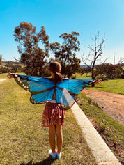 Vibrant butterfly wings for kids, custom chiffon designs with glitter and sparkle, perfect for dress-up or dance.