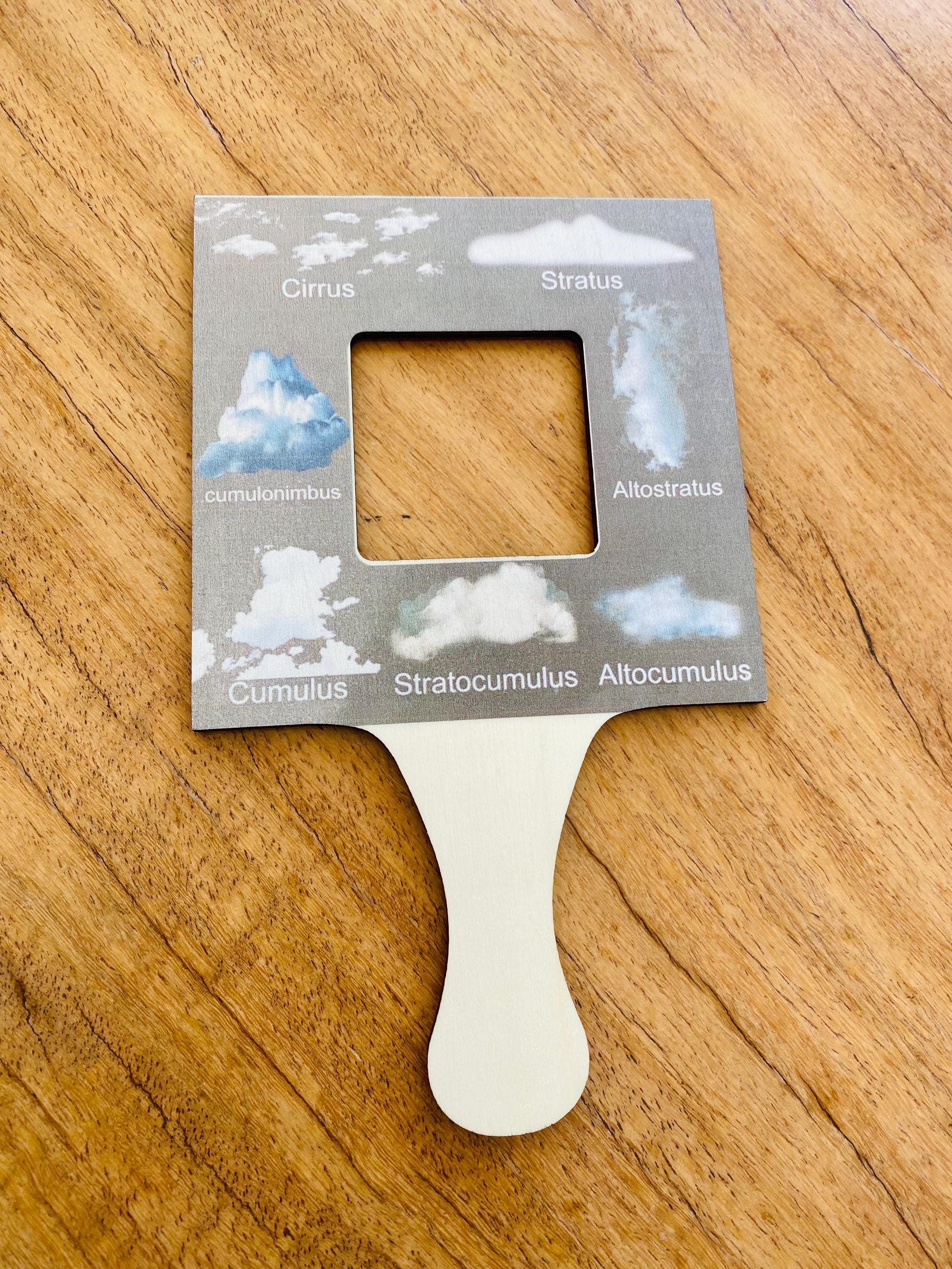 kids wooden view finder: nature exploration tool for observing clouds and leaves.
