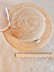 Straw hat with ribbon and floral accents, perfect for crafting, wall decor, or doll dress-up.