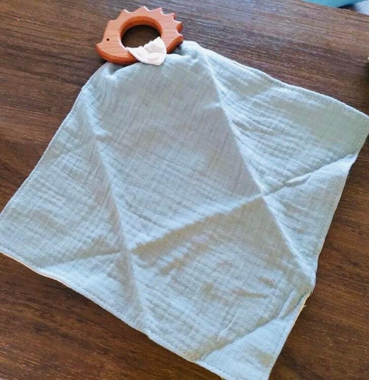 Meet your spiky sidekick: a cozy echidna plush with a blanket for snuggly moments.