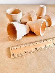 Natural mini wooden flower pots, ideal for sensory play, small-world setups, or gardening fun.