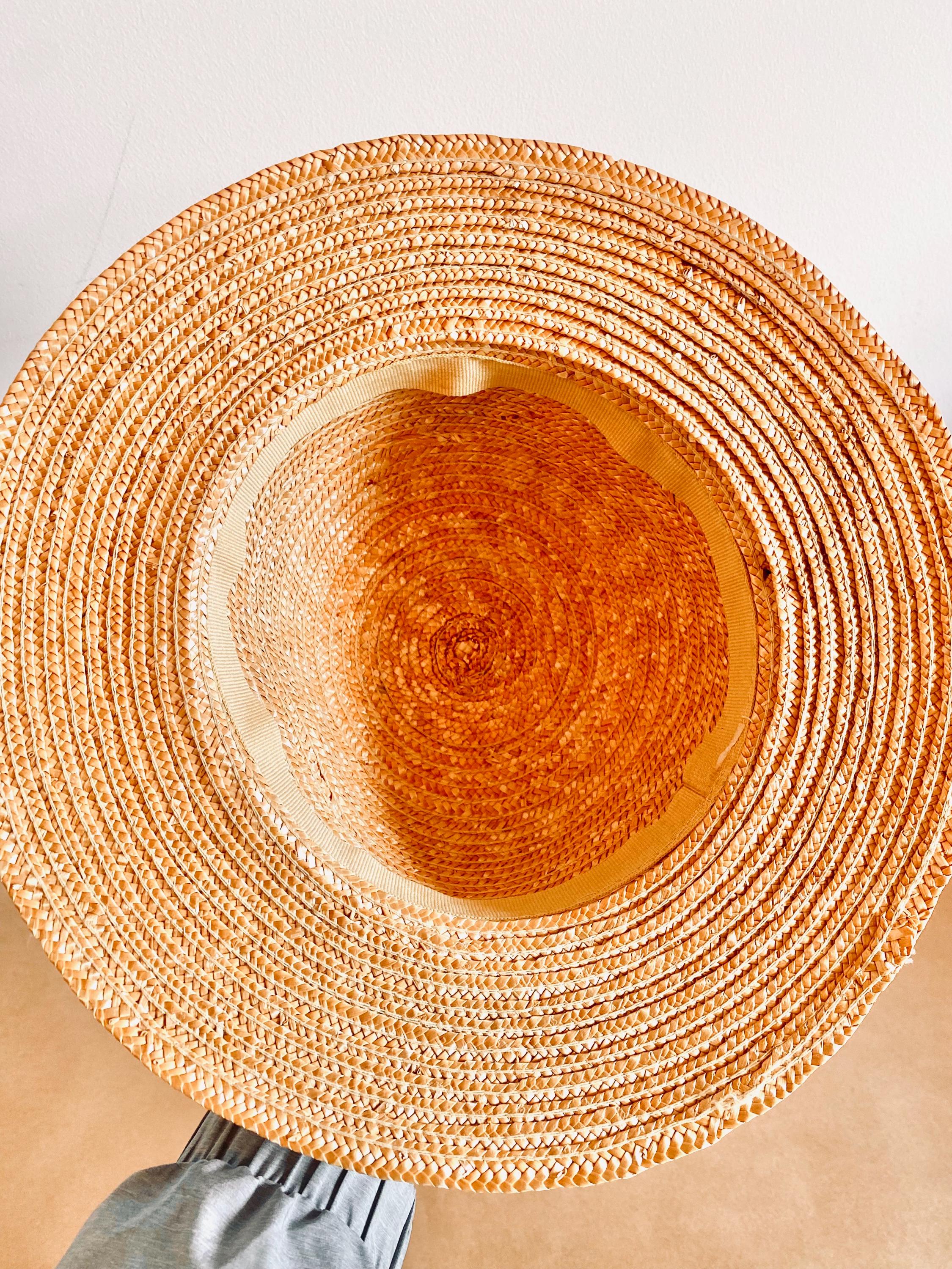 Straw hat with ribbon and floral accents, perfect for crafting, wall decor, or doll dress-up.