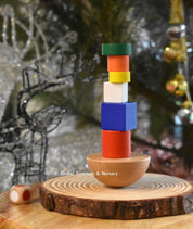 Colorful 8-piece wooden geometric block balancing game. Perfect for improving motor skills and encouraging STEM learning through play.
