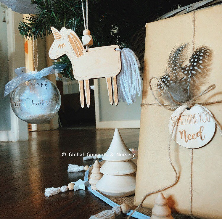 Unicorn Tassel Ornament: Wooden unicorn ornament with tassels and beads for holiday decor.