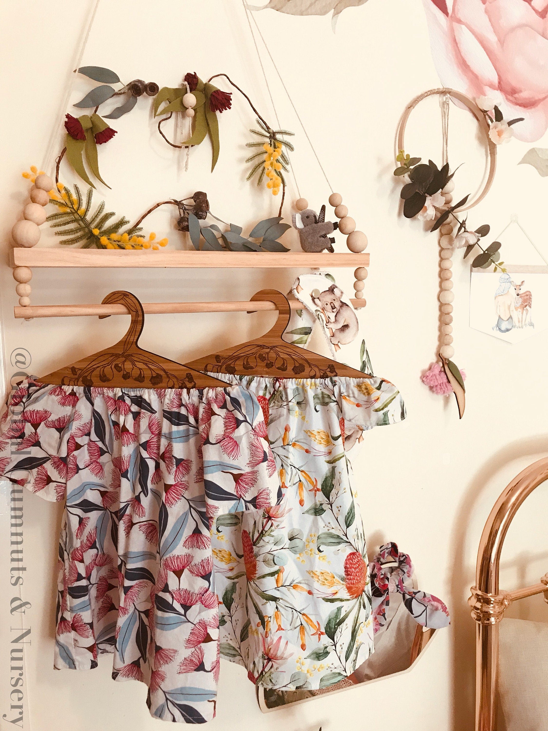 Wooden coat hanger featuring gumnuts and eucalyptus designs, bringing a touch of Australian nature to your closet.