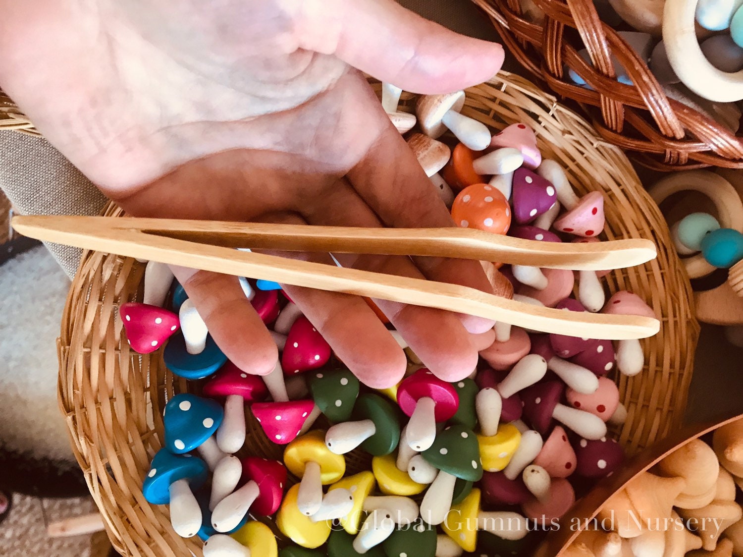 Wooden Toddler Tongs: Curved wooden tongs designed for toddlers' motor skill development.