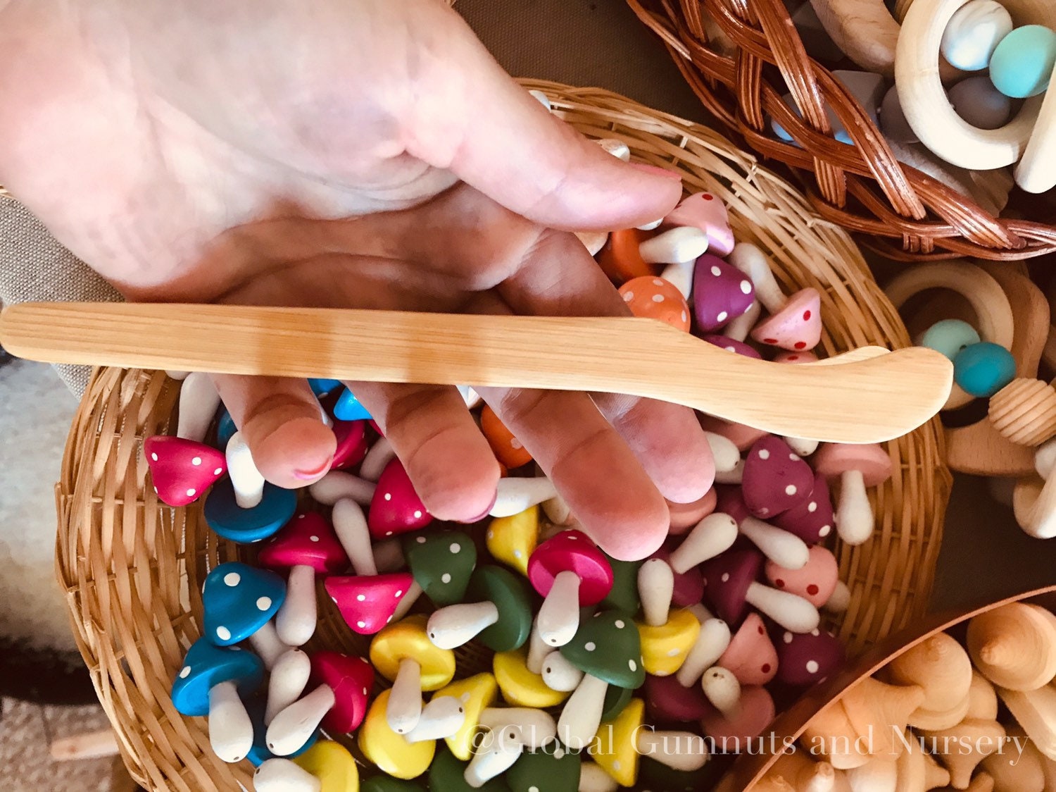 Wooden Toddler Tongs: Curved wooden tongs designed for toddlers' motor skill development.