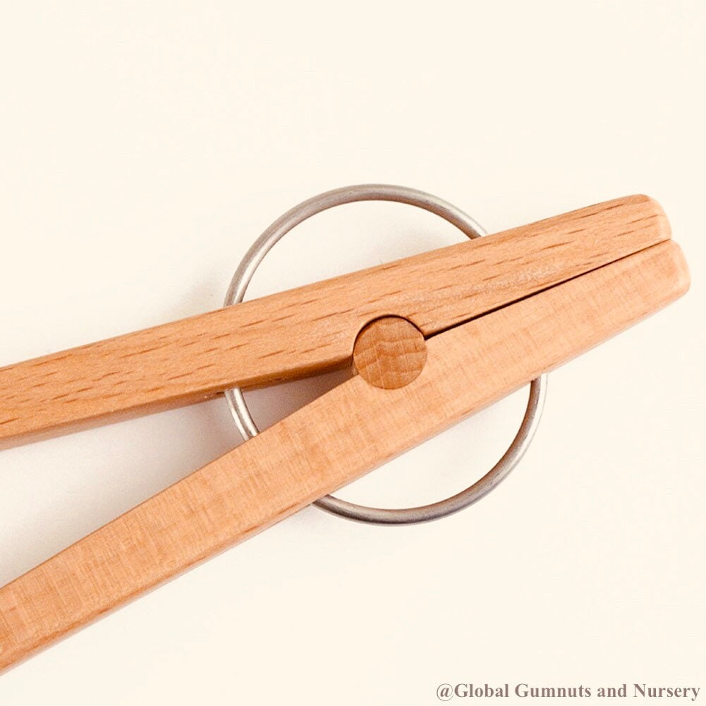 Wooden springy tongs, chopstick-like fun for kids or kitchen use.