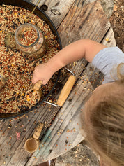 Water play scoop with holes in a bucket, perfect for sensory or outdoor play.