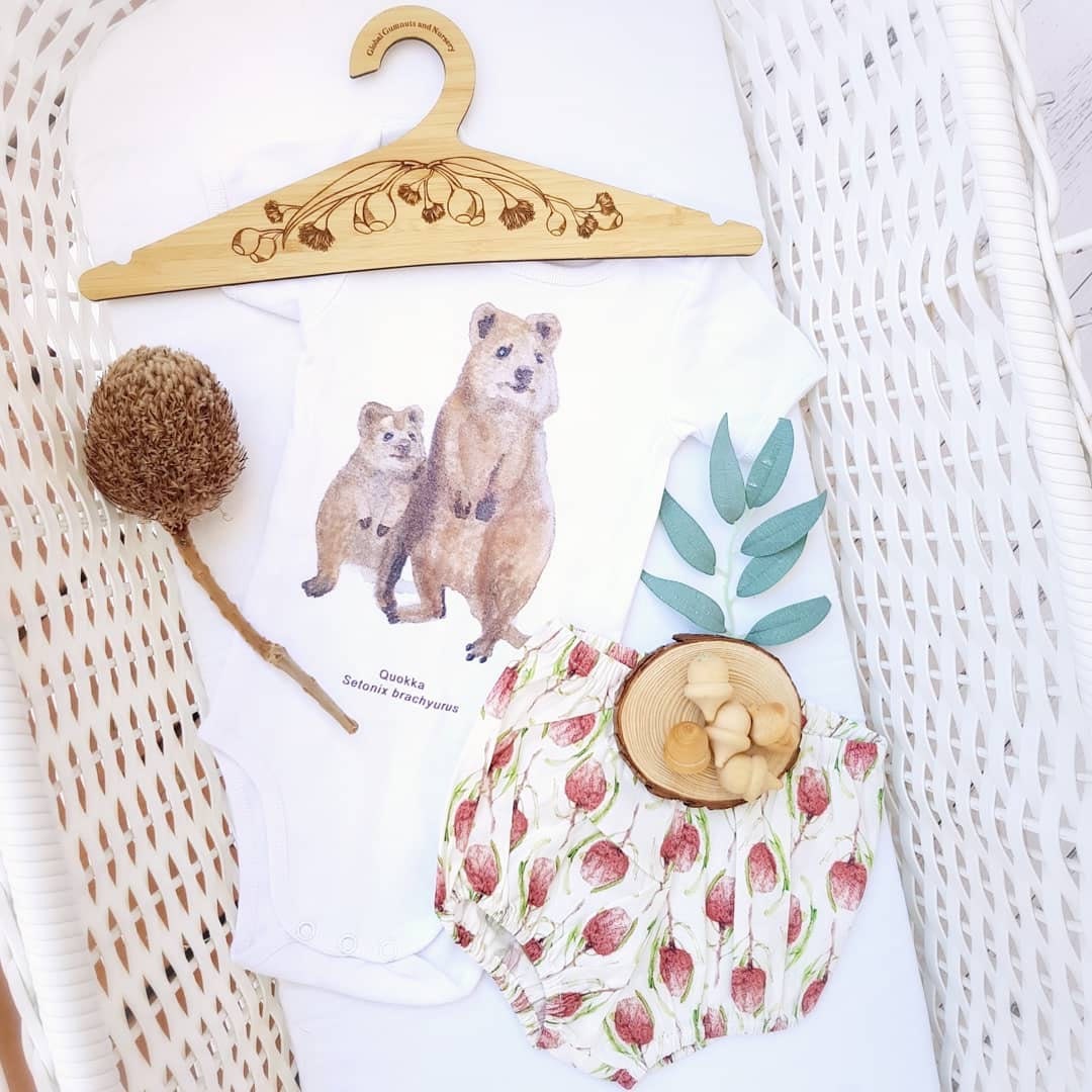 Wooden coat hanger featuring gumnuts and eucalyptus designs, bringing a touch of Australian nature to your closet.