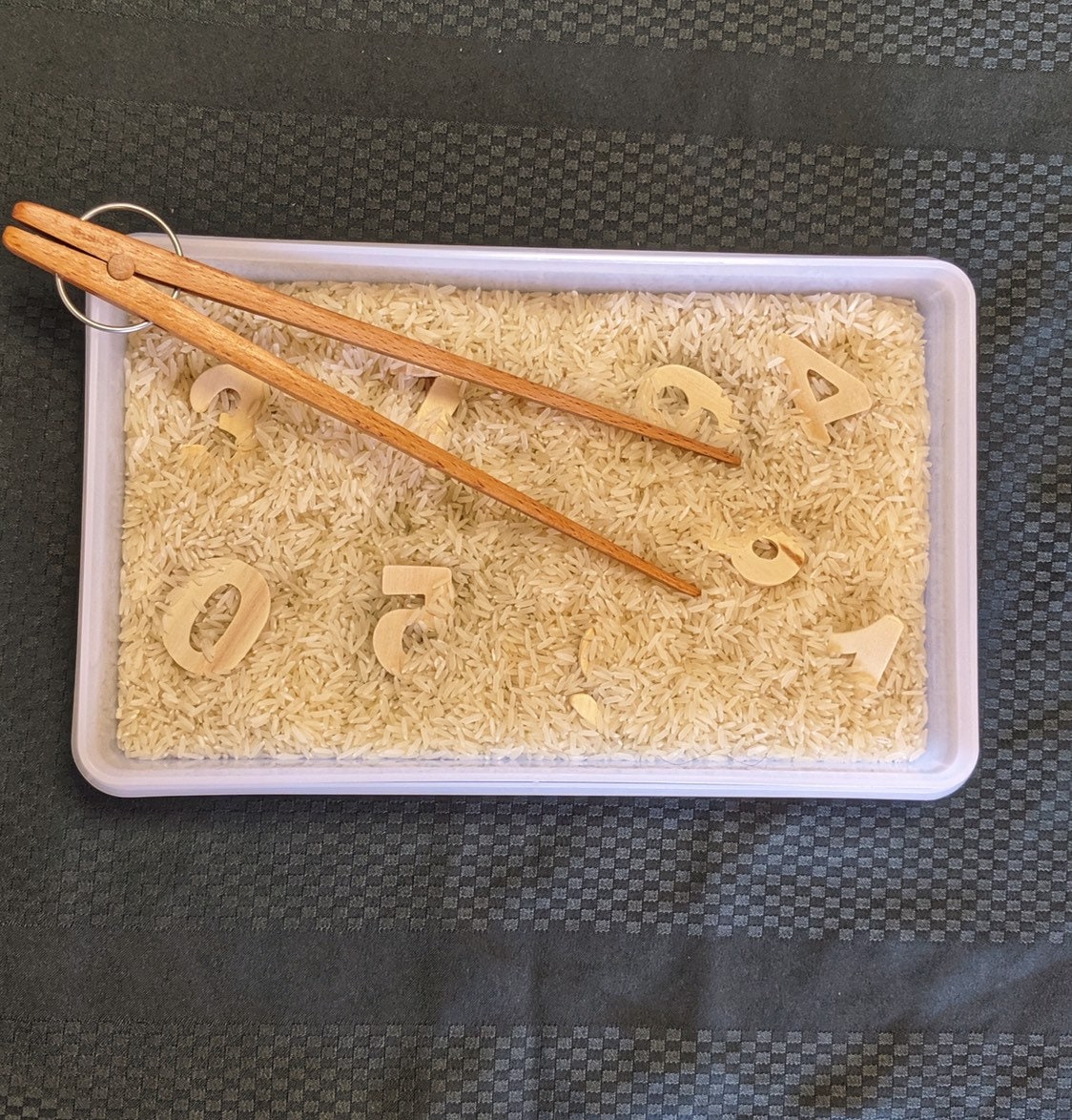 Wooden springy tongs, chopstick-like fun for kids or kitchen use.