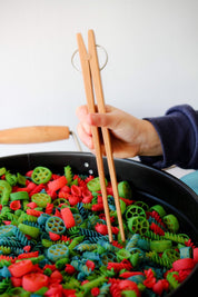 Wooden springy tongs, chopstick-like fun for kids or kitchen use.