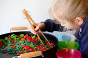 Wooden springy tongs, chopstick-like fun for kids or kitchen use.