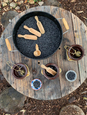 Water play scoop with holes in a bucket, perfect for sensory or outdoor play.