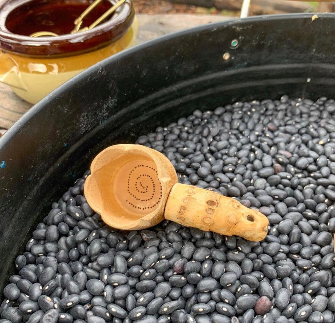 Water play scoop with holes in a bucket, perfect for sensory or outdoor play.
