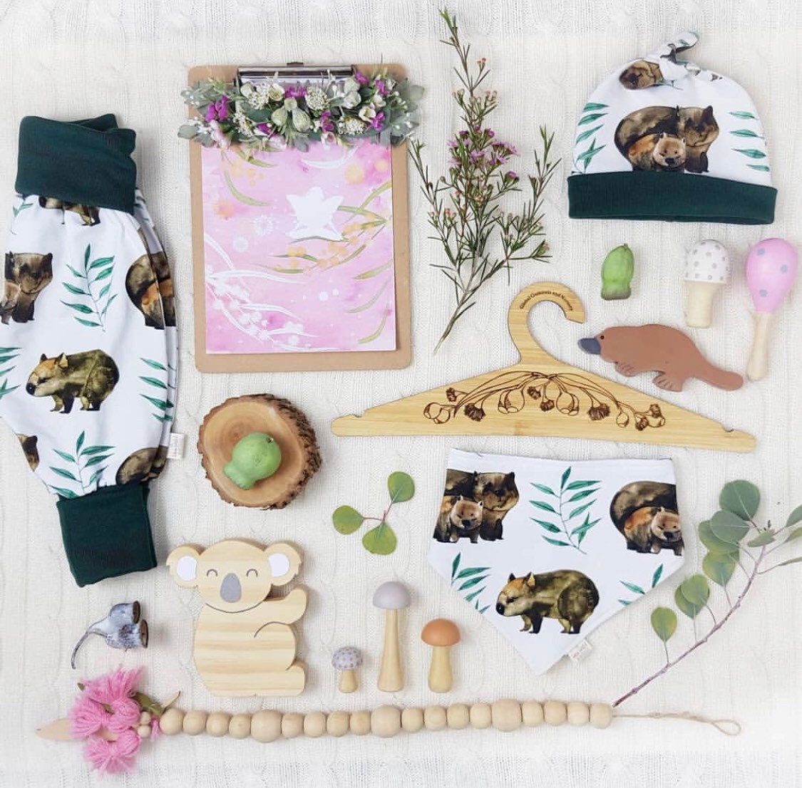 Wooden coat hanger featuring gumnuts and eucalyptus designs, bringing a touch of Australian nature to your closet.