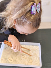 Wooden springy tongs, chopstick-like fun for kids or kitchen use.