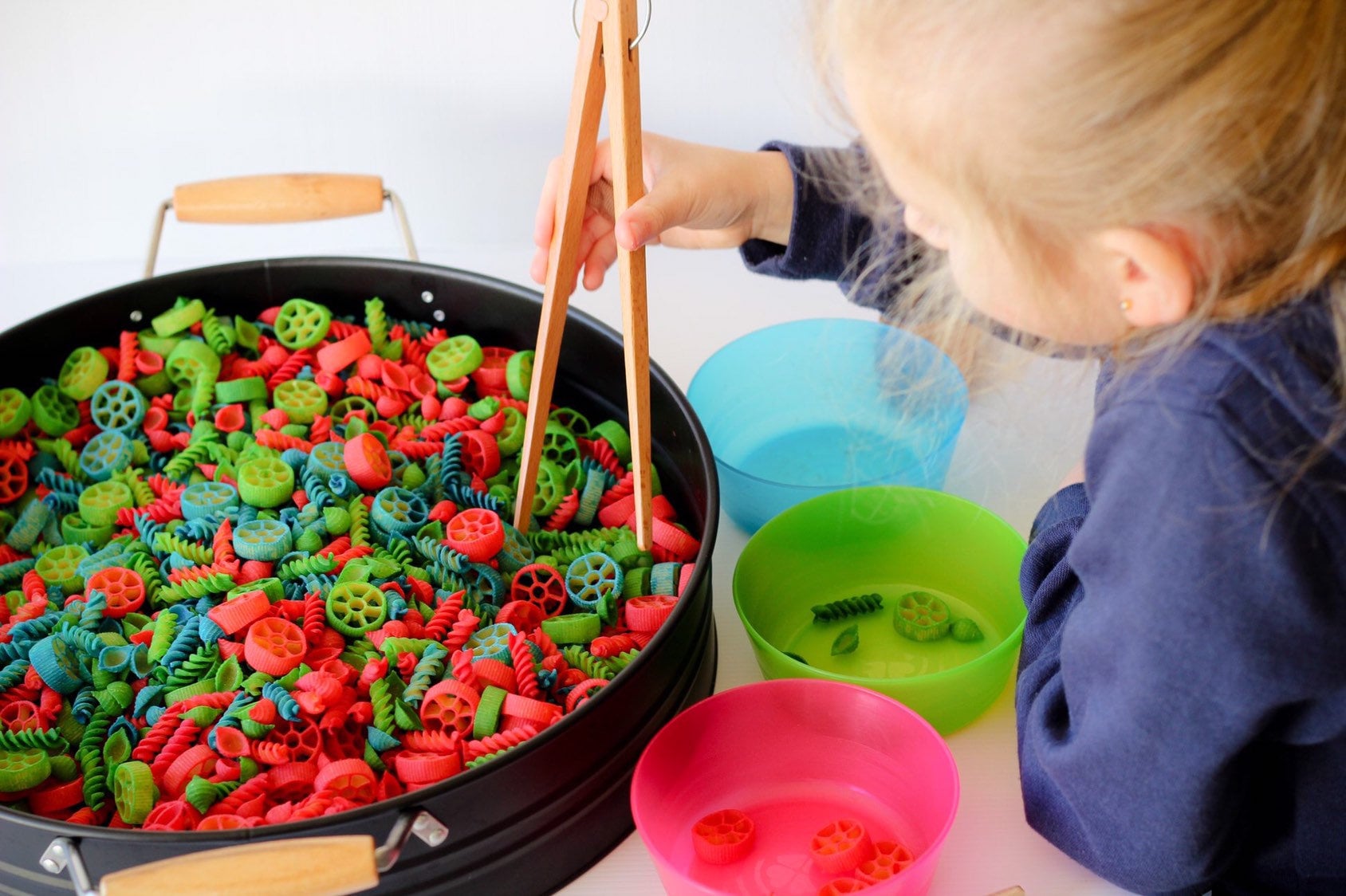 Wooden springy tongs, chopstick-like fun for kids or kitchen use.