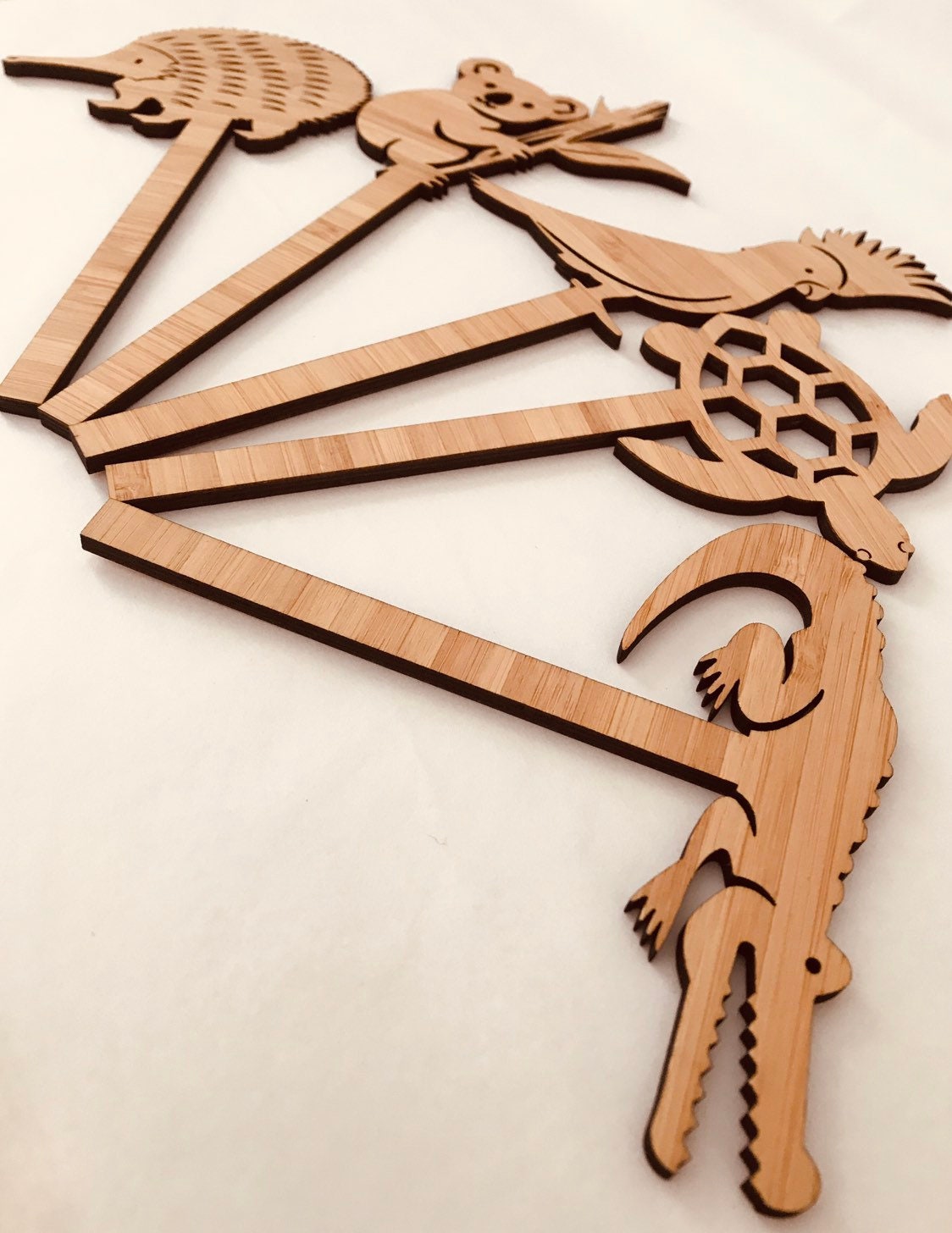 Individual wooden Australian animal puppets featuring emu, koala, crocodile, and more for play or storytelling.