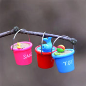 Miniature beach buckets for small-world play. Perfect for imaginative beach or summer-themed setups.