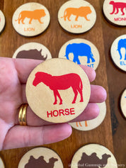 Matching animal game with wooden discs, a Montessori-inspired matching toy.
