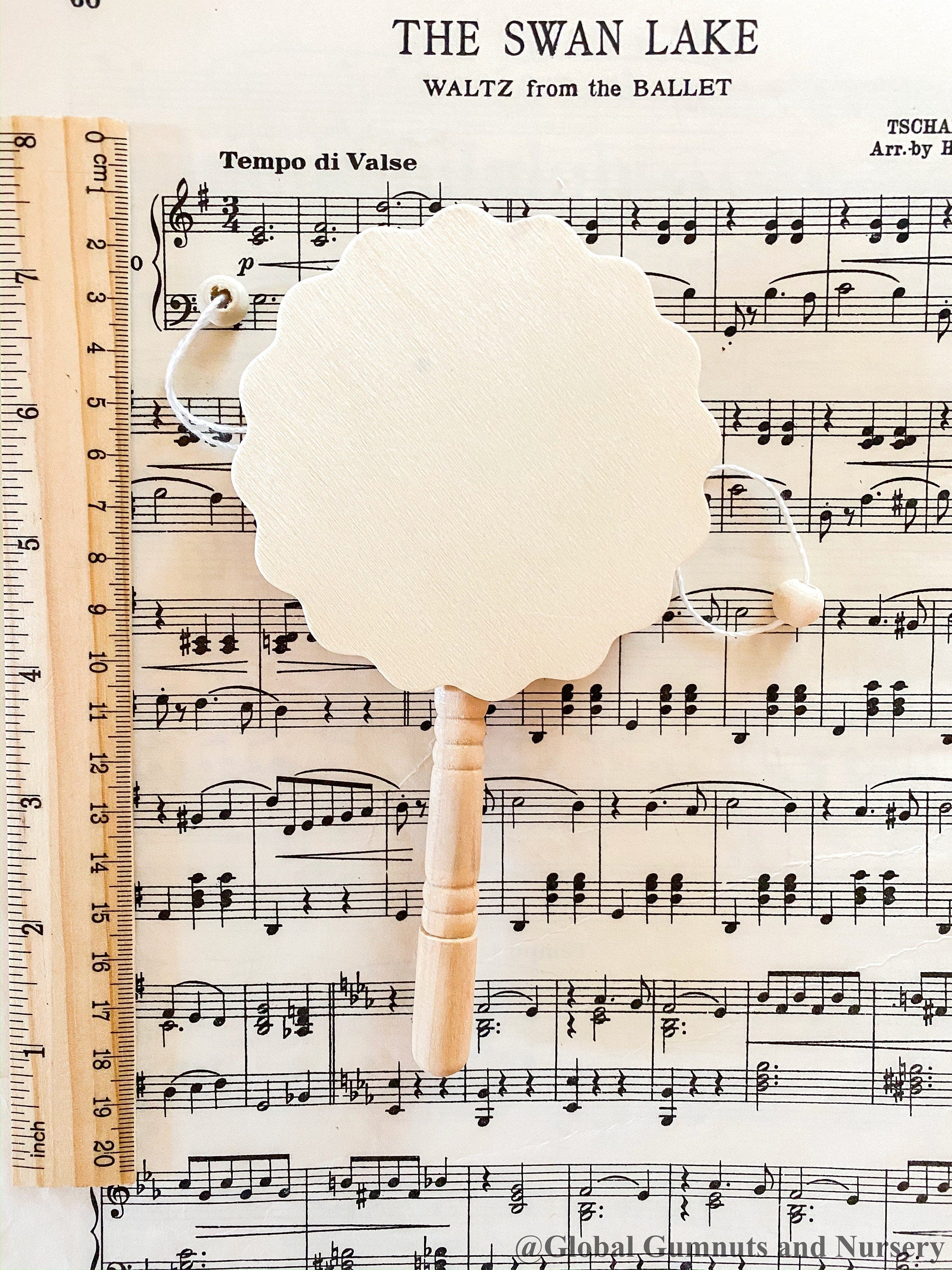 Natural wooden rattle drum, an engaging and eco-friendly musical toy for babies.
