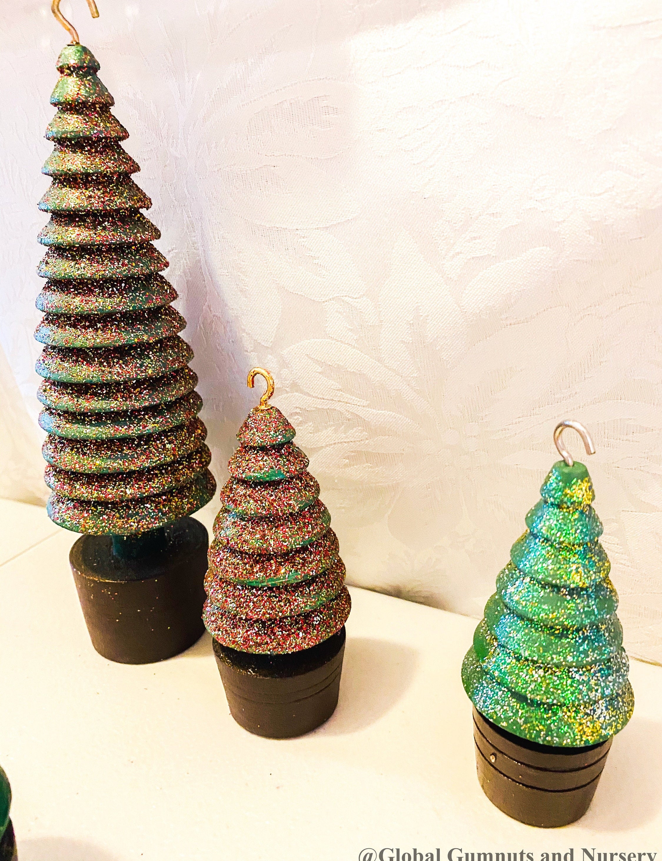 Glittery handmade wooden Christmas trees, creating a magical forest decor for the holiday season.